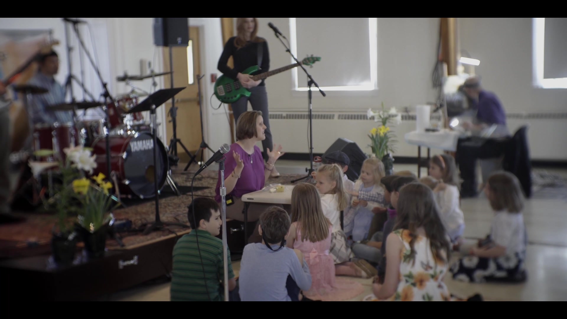Children, families, and musicians sharing the relaxed Common Ground worship space